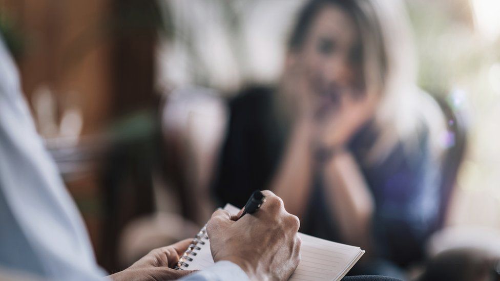 a person writing on a piece of paper