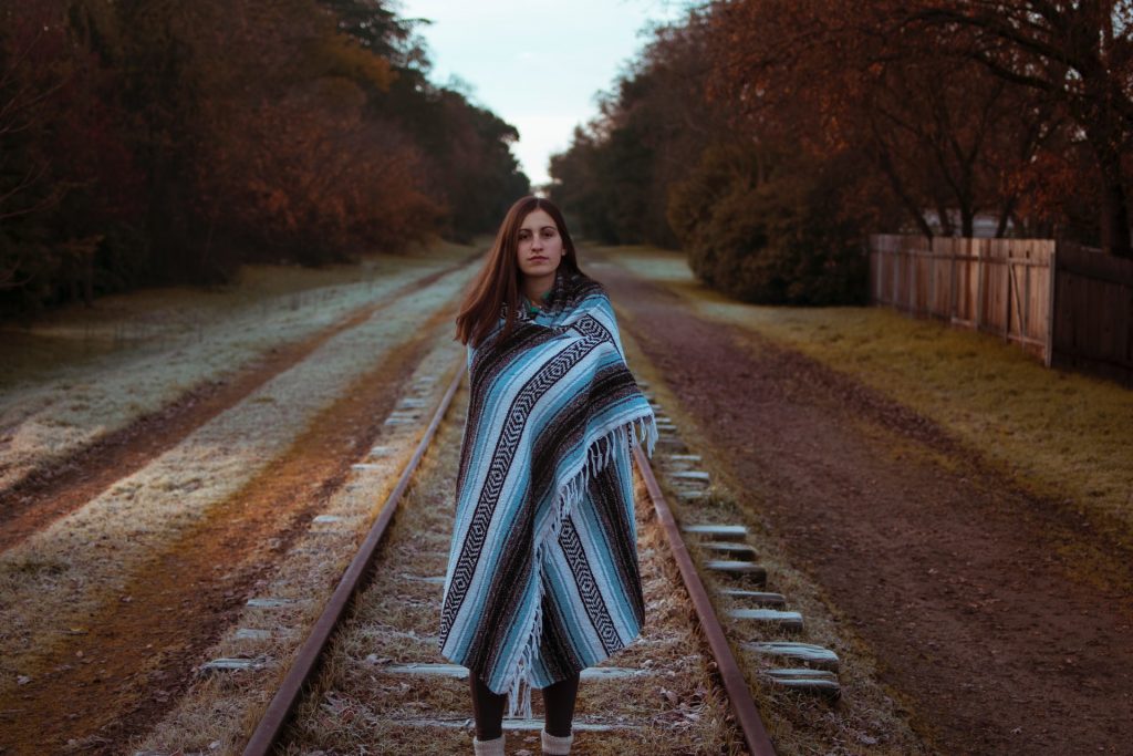 a woman standing on a railroad track